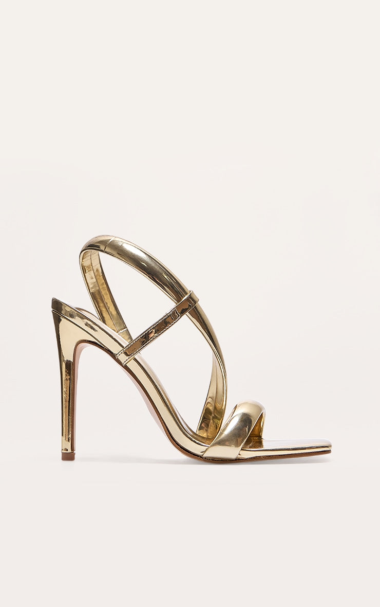 https://cdn-img.prettylittlething.com/0/7/9/0/079008678dc46ccd8917538177008151cd56d7d0_CNJ5048_1_gold_metallic_pu_square_toe_padded_asymmetric_high_heeled_sandals.jpg