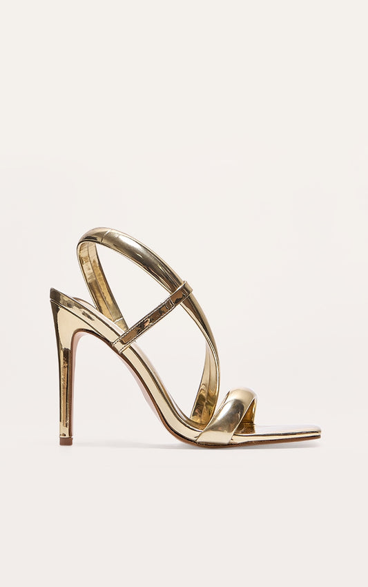 https://cdn-img.prettylittlething.com/0/7/9/0/079008678dc46ccd8917538177008151cd56d7d0_CNJ5048_1_gold_metallic_pu_square_toe_padded_asymmetric_high_heeled_sandals.jpg