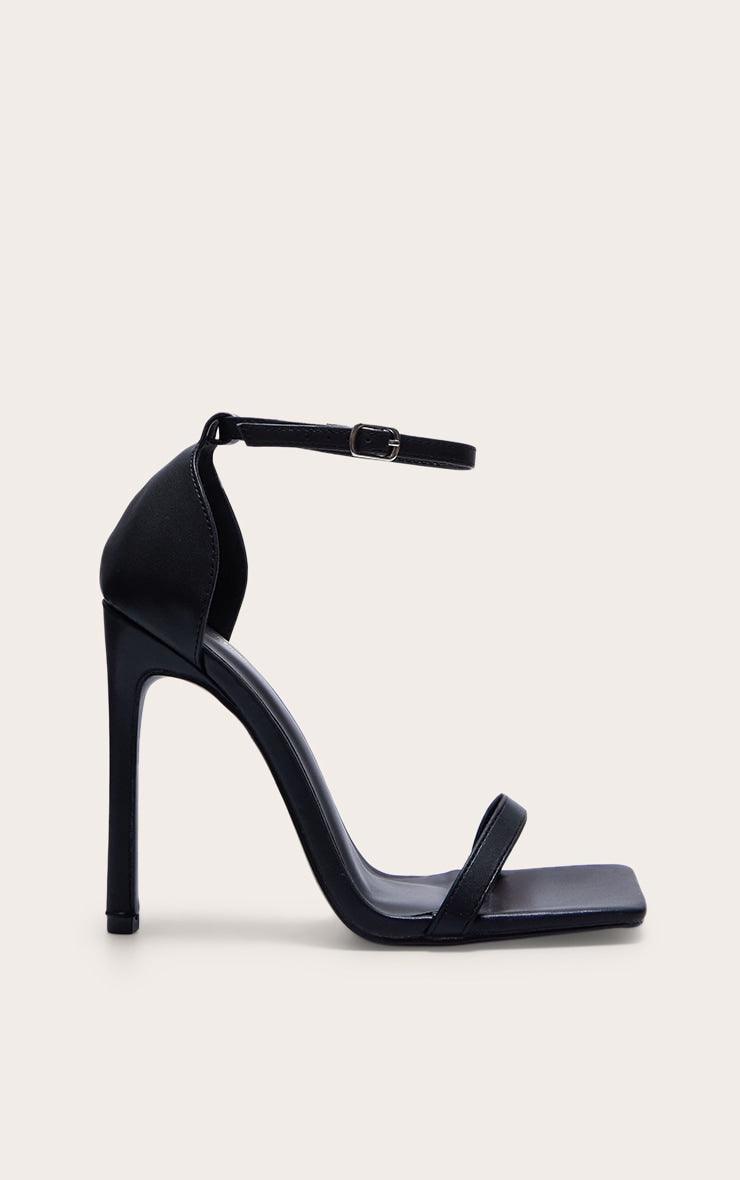 https://cdn-img.prettylittlething.com/2/9/f/1/29f178bed7526bb595f71d658eb1de28b6030f22_CMQ0466_1_black_wide_fit_pu_barely_there_strappy_heeled_sandals.jpg