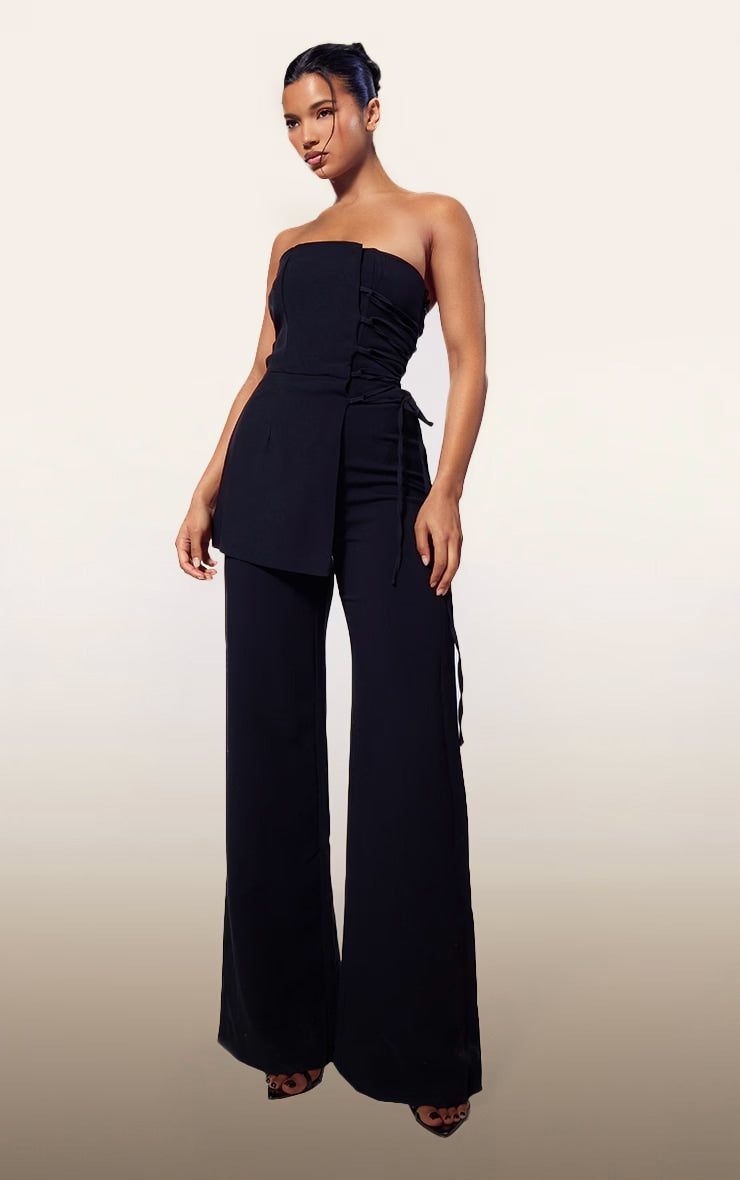 https://cdn-img.prettylittlething.com/7/b/e/7/7be778809eacb3dae211c1fab38d1525cd06ab33_CNH5809_1_plt_label_black_overlay_panel_lace_up_tailored_jumpsuit.jpg