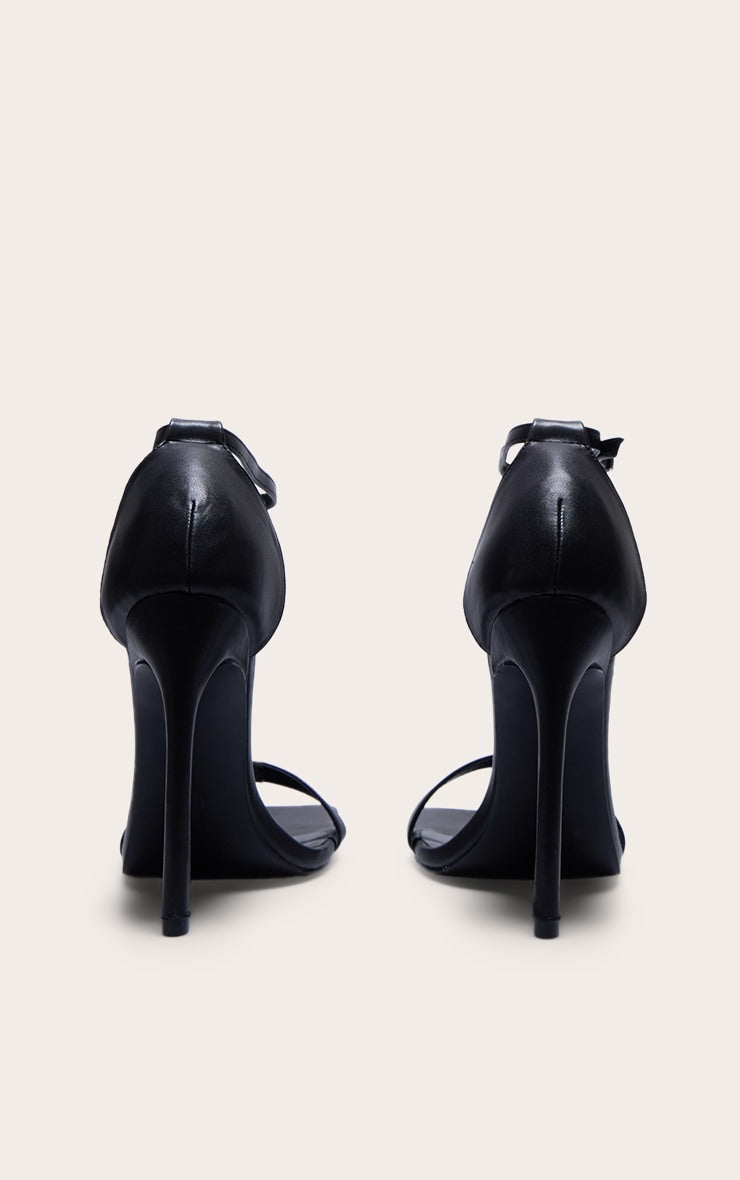 https://cdn-img.prettylittlething.com/c/2/d/f/c2dffd0029f0a59eaf7e85daff799c0186b695cd_CMQ0466_3_black_wide_fit_pu_barely_there_strappy_heeled_sandals.jpg